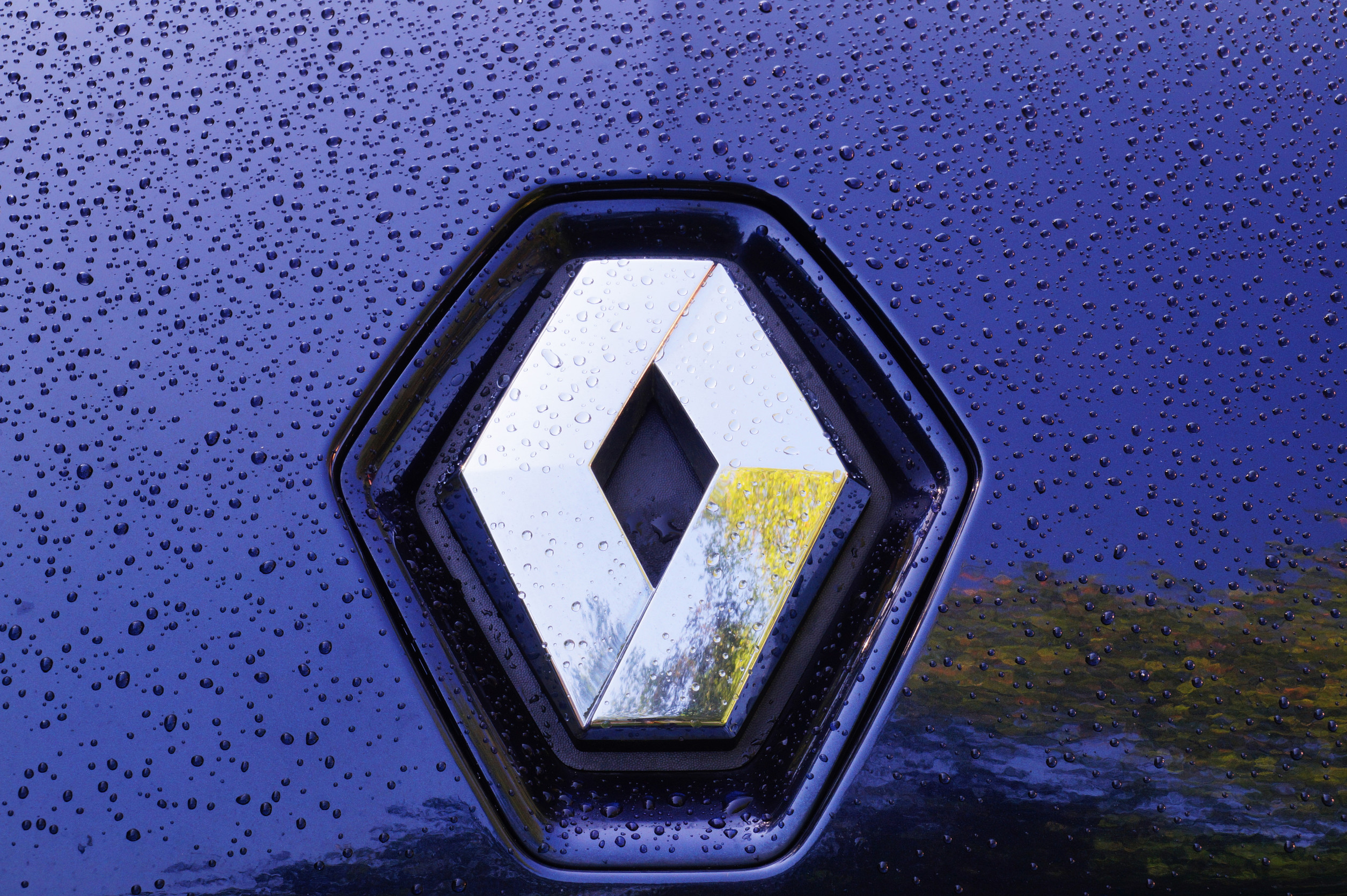 Renault trademark. Raindrops on the car's metallic paint. France